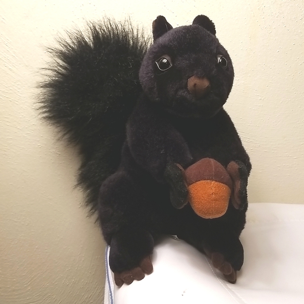 Sitting Black Squirrel Holding Acorn plush stuffed animal